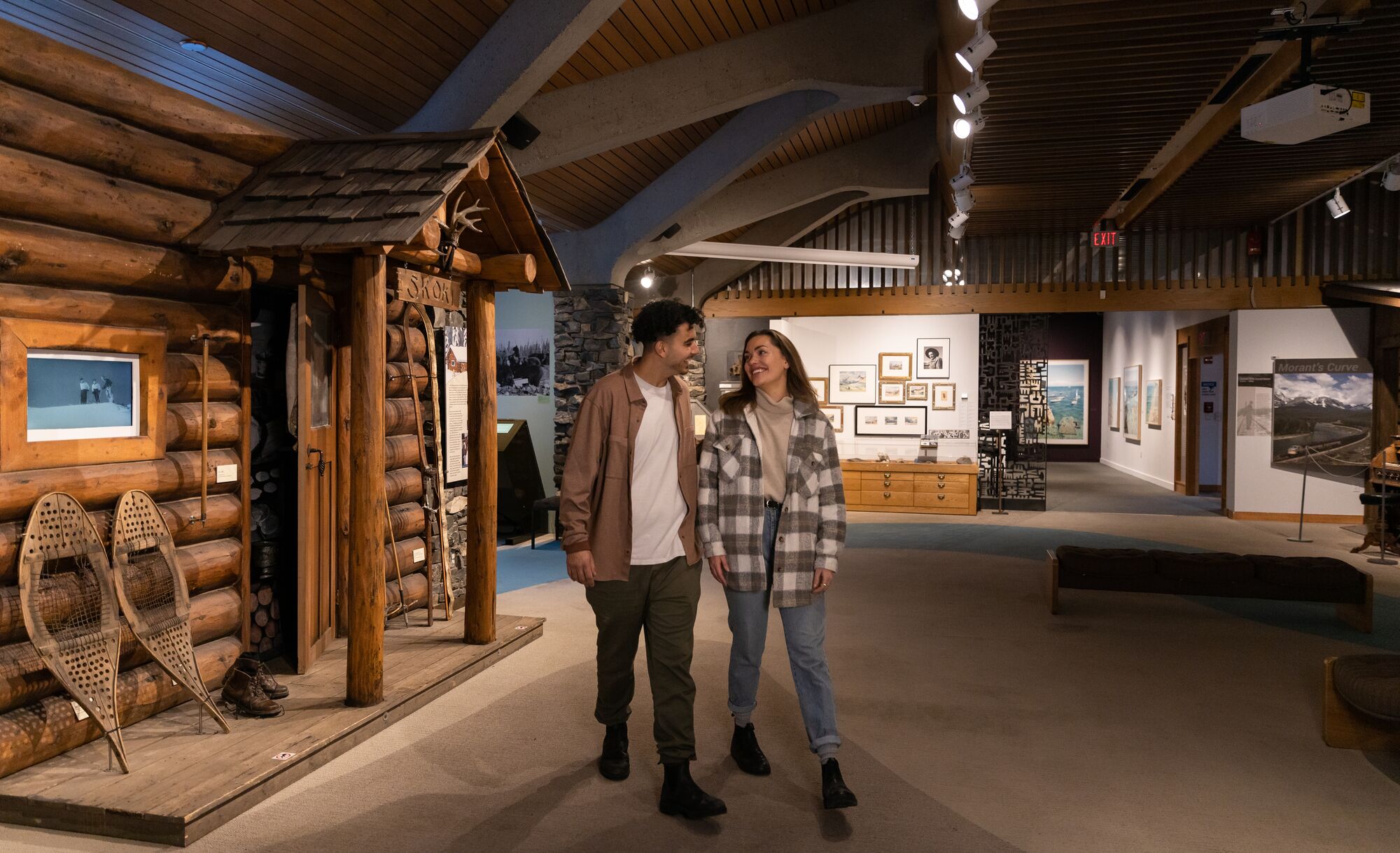 Two people walk through the Whyte Museum of the Canadian Rockies.